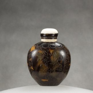 O9 A tortoise shell incised snuff bottle