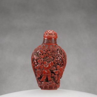 O7 A carved cinnabar lacquer “Kids playing” snuff bottle